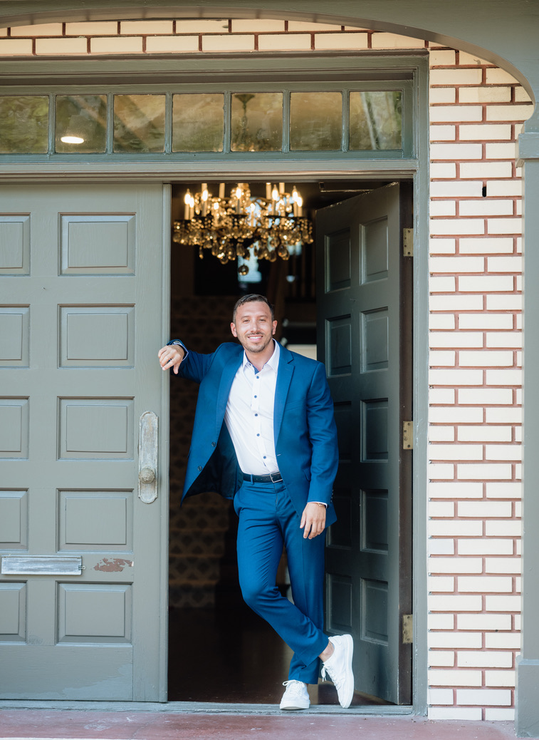 Tony in the doorway of a historic building